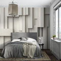 Modern 3D geometric wallpaper adding depth to a minimalist living room with grey sofa and natural light