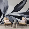 Black and white botanical wallpaper creating dramatic impact in modern living room with tall windows and minimal furniture
