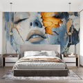 Abstract portrait wallpaper with blue and gold tones creating drama in a modern living room setting