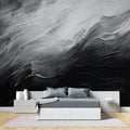 Black and white abstract wallpaper creating drama in a modern living room setting