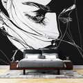 Black and white line art portrait mural wallpaper styled in a modern living room with minimal furniture