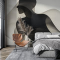 Abstract black and white silhouette wallpaper creating dramatic impact in a modern living room with minimalist furniture