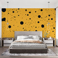 Modern home office featuring yellow and black polka dot wallpaper creating an energetic workspace atmosphere