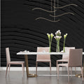 Black wave wallpaper creating dramatic effect in modern living room with leather sofa