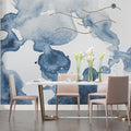 Blue watercolor abstract wallpaper in modern living room with grey sofa and natural light