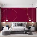 Burgundy and gold geometric wallpaper adding luxury to a modern living room with clean-lined furniture