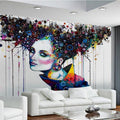 Abstract portrait wallpaper creating a bold statement in a modern living room with minimalist furniture