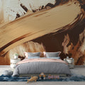 Abstract brushstroke wallpaper in beige and brown tones creating a dramatic focal point in a modern living room setting
