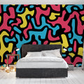 Abstract pattern wallpaper creating a bold statement wall in a modern living room with minimalist furniture