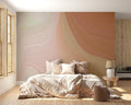 Abstract flowing lines wallpaper in terracotta and beige tones creating movement in a modern living room setting