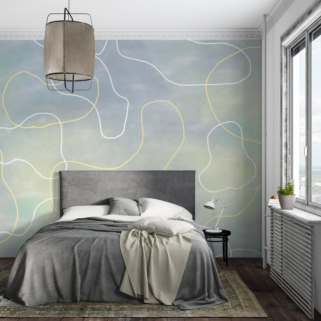 Abstract curve wallpaper creating a calm atmosphere in a modern living room with grey sofa and natural light