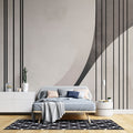 Modern geometric wallpaper with clean lines and curves creates striking impact in a minimalist living room setting
