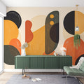 Modern geometric abstract wallpaper with terracotta and gold shapes creating depth in a bright living room setting