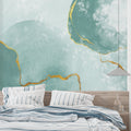 Modern living room with mint green and gold abstract wallpaper creating a fresh, airy atmosphere