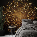 Black and gold abstract wallpaper creating dramatic impact in modern living room with floating golden spheres catching light