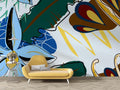 Modern botanical abstract wallpaper creating a stunning focal point in a bright living room with minimal furniture