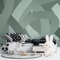 Modern geometric wallpaper in sage green showcased in a minimalist living room with natural light