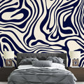 Navy blue abstract fluid wallpaper creating a stunning backdrop in a modern minimalist living room with natural lighting