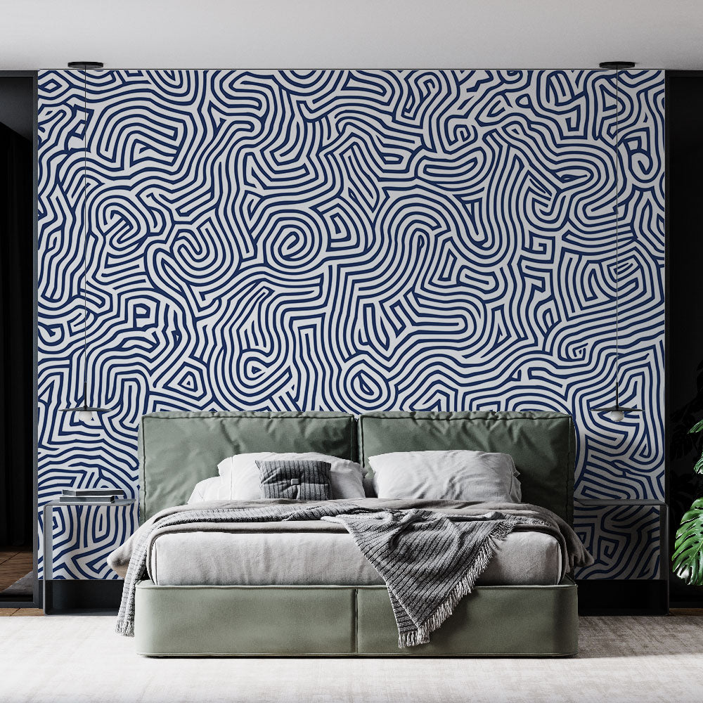 Navy blue geometric wallpaper creating a stunning focal point in a modern living room with clean furniture and natural light
