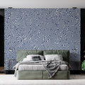 Navy blue geometric wallpaper creating a stunning focal point in a modern living room with clean furniture and natural light