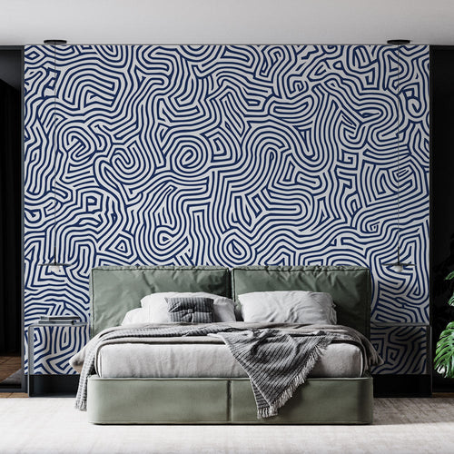 Navy blue geometric wallpaper creating a stunning focal point in a modern living room with clean furniture and natural light