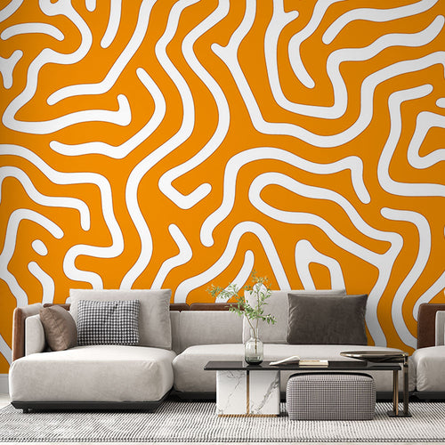 Orange geometric abstract wallpaper mural showcased in a modern living room with white furniture and natural light