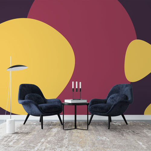 Abstract circle wallpaper in yellow and burgundy tones creating a modern statement wall in a bright living room setting