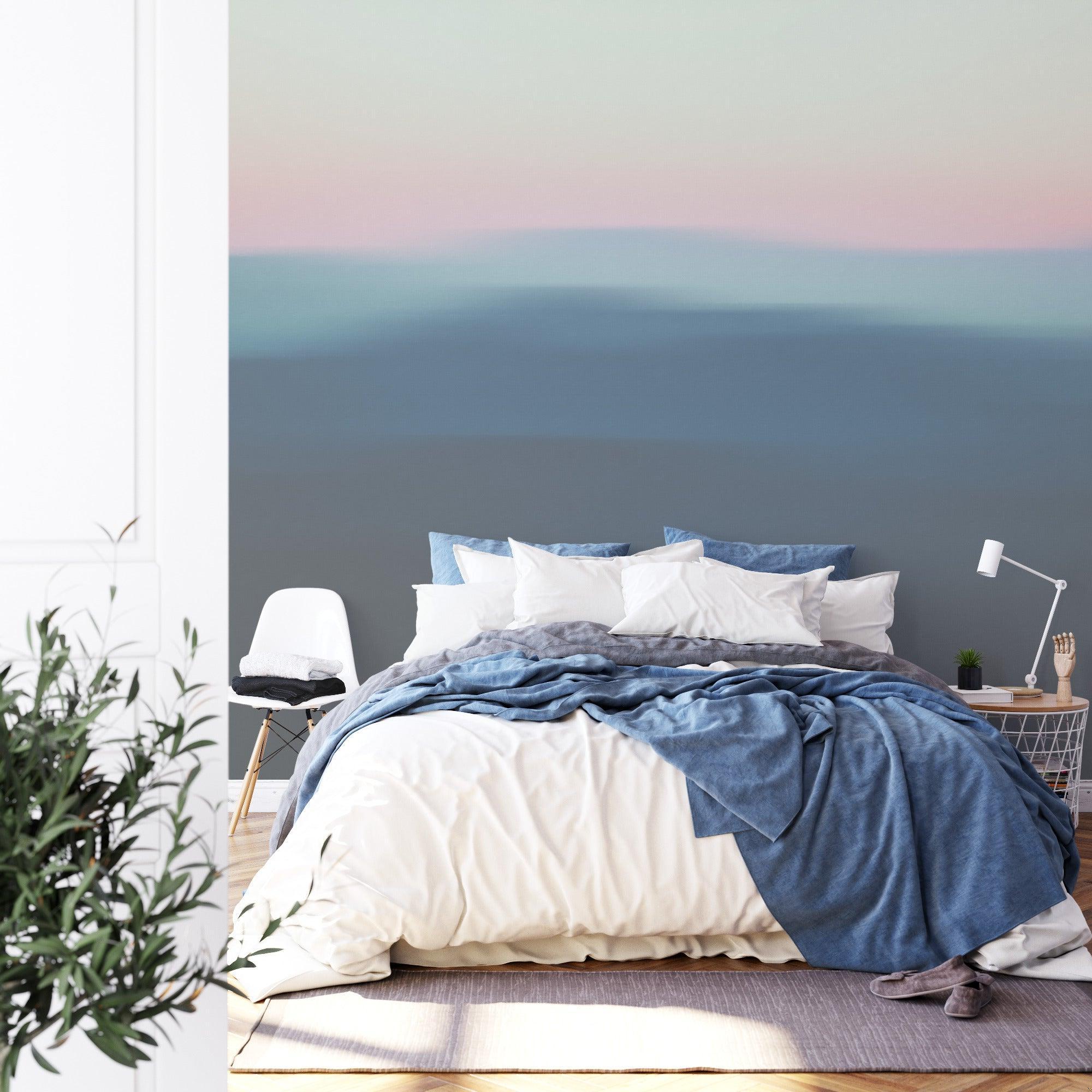 Minimalist bedroom featuring abstract hills gradient mural in soft pink and blue tones