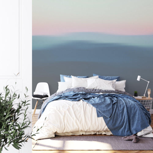 Minimalist bedroom featuring abstract hills gradient mural in soft pink and blue tones