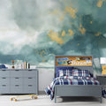 Watercolor cloud wallpaper with gold accents in a bright modern living room creating an airy atmosphere