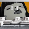 Abstract portrait wallpaper creating dramatic impact in a modern living room with black and white face art against orange
