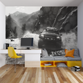 Black and white rally car wallpaper creating drama in a modern living room with high ceilings