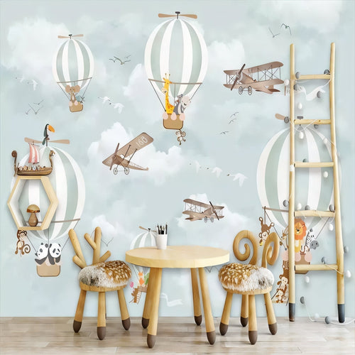 Hot air balloon animal wallpaper in a bright nursery with white furniture