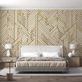 Gold geometric Art Deco wallpaper creating drama in a modern living room with high ceilings and minimal furniture