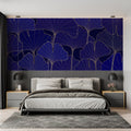 Navy and gold Art Deco wallpaper with ginkgo leaves pattern in modern living room creating elegant atmosphere