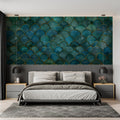 Art deco teal and gold scale wallpaper in modern living room with grey sofa and brass accents