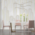 Art deco gold arch wallpaper in modern living room with grey sofa and natural light