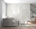 White and gold geometric art deco wallpaper in modern living room with high ceilings and minimalist furniture