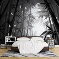 Black and white bamboo forest wallpaper creating a zen atmosphere in a modern minimalist living room with natural light