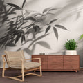 Black and white bamboo shadow wallpaper creating a zen atmosphere in a modern minimalist living room