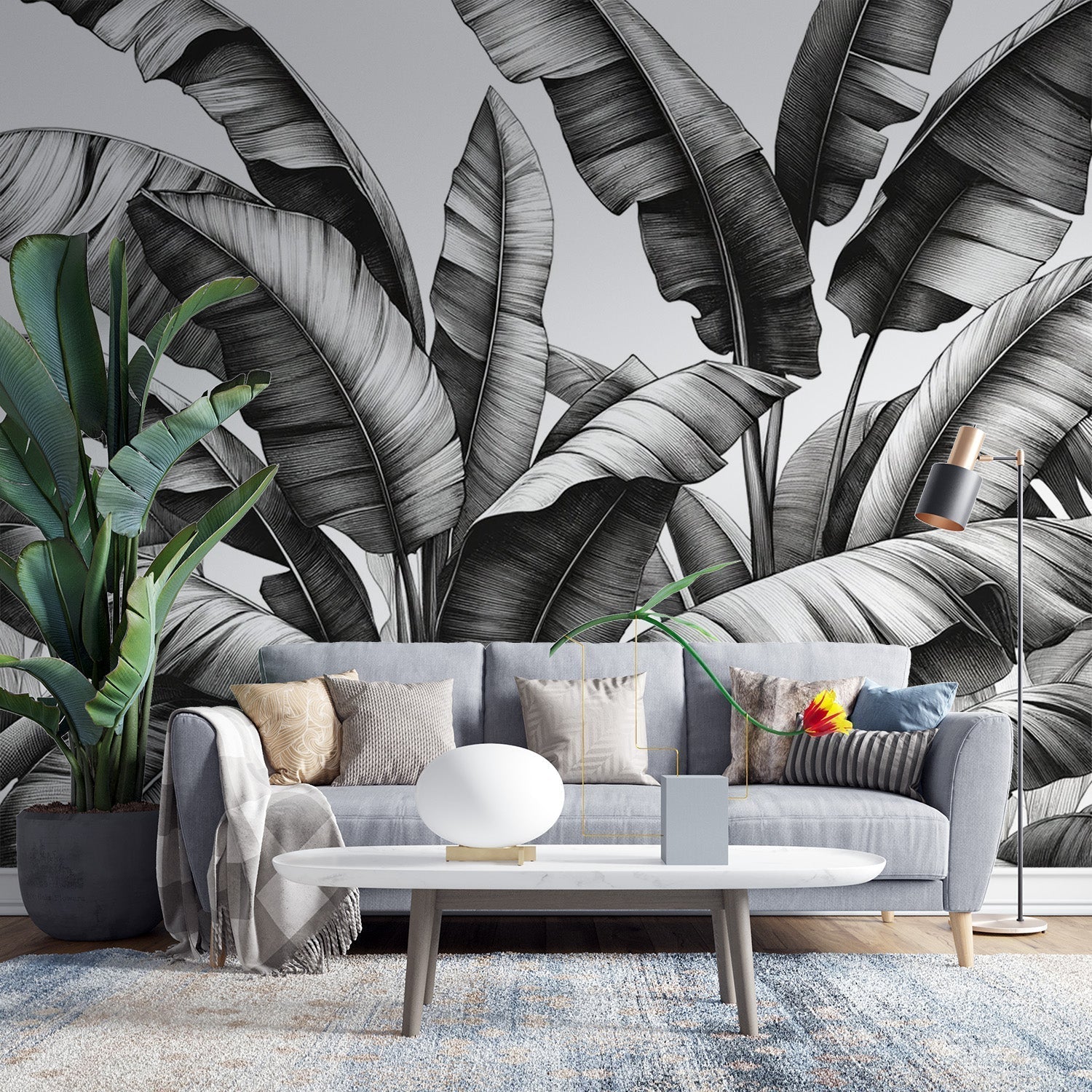 Black and white botanical wallpaper creating drama in a modern living room with clean lines and natural light