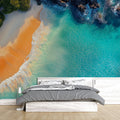 Coastal paradise beach wallpaper creating a bright, airy atmosphere in a modern living room with white furniture