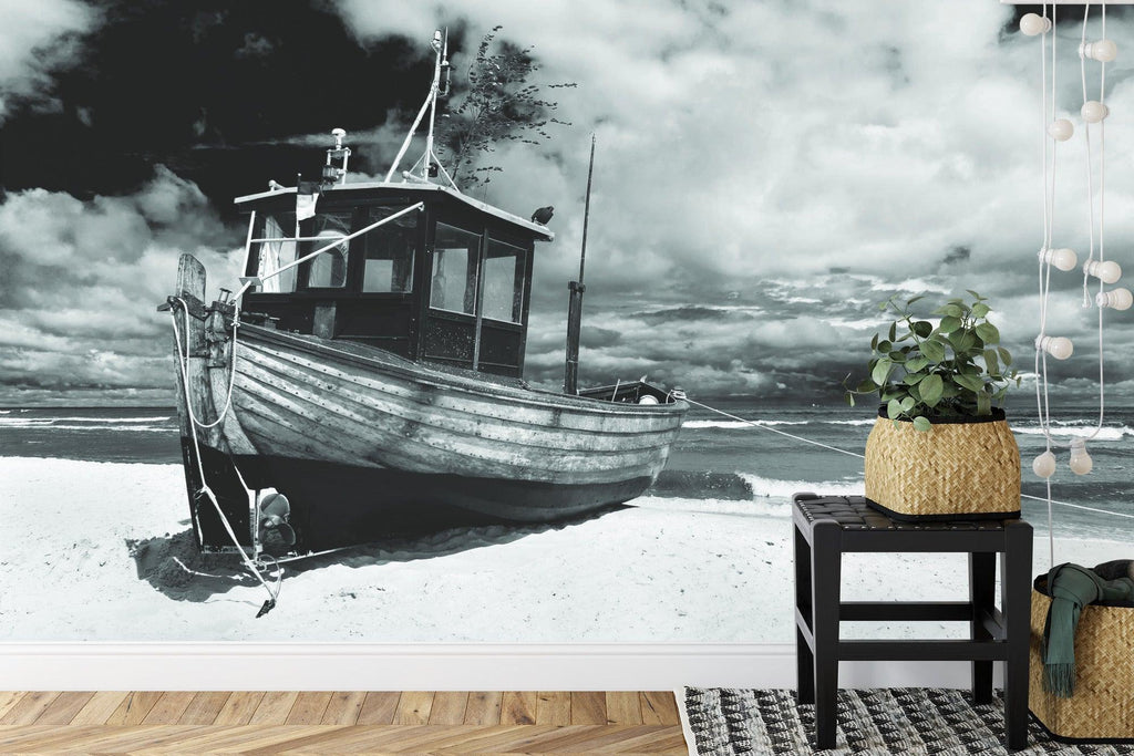 Beach wall mural creating peaceful atmosphere in modern living room with monochrome fishing boat design