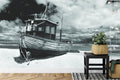 Beach wall mural creating peaceful atmosphere in modern living room with monochrome fishing boat design