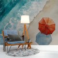 Beach scene wallpaper with red parasol transforms this bright living room into a coastal retreat