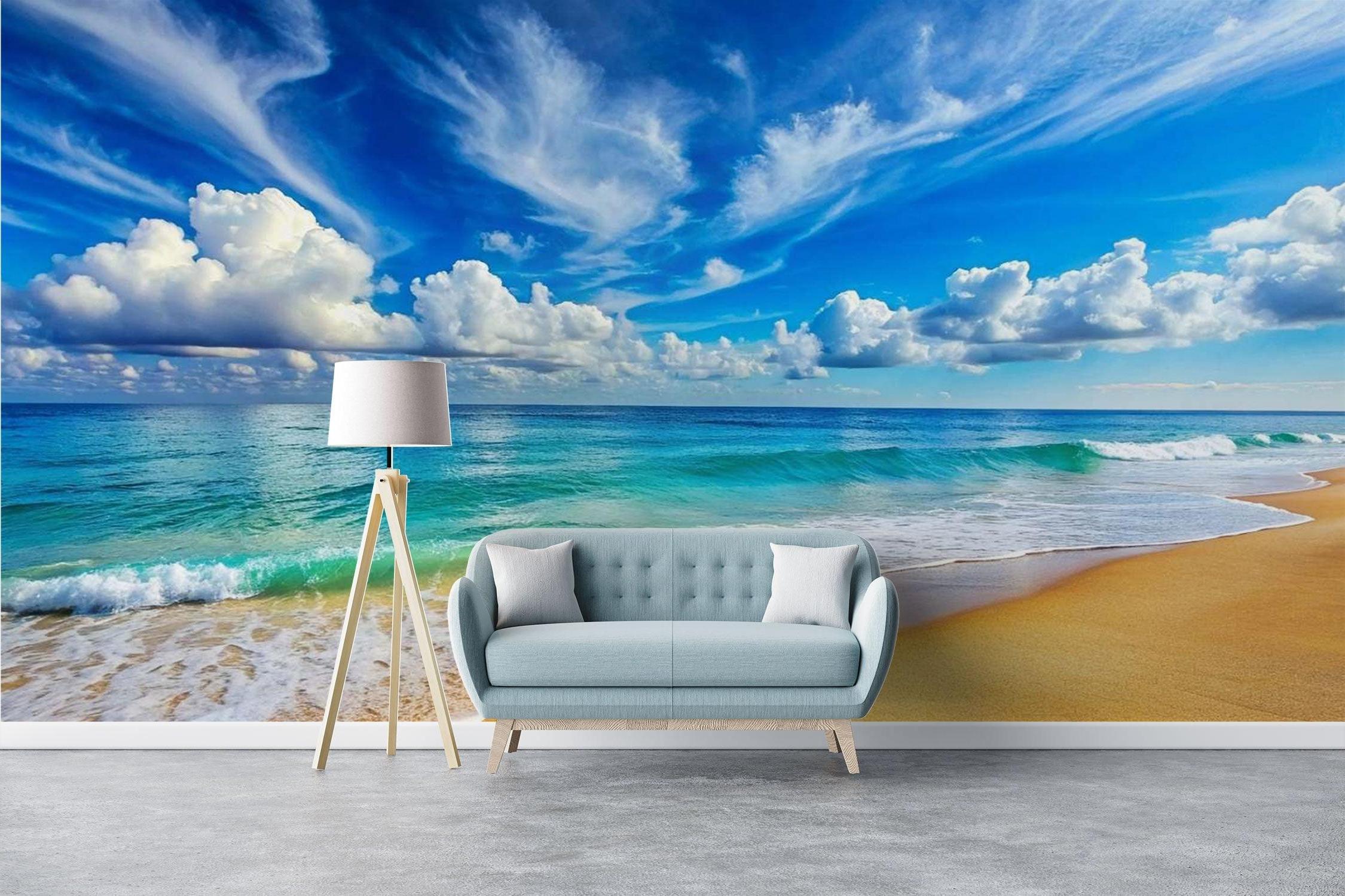 Beach wallpaper mural in modern living room with white sofa and natural light