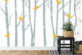 Birch forest wallpaper with yellow birds in a bright Scandinavian living room setting