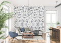 Blue Toile de Jouy bird wallpaper in a bright dining room with white wainscoting and crystal chandelier