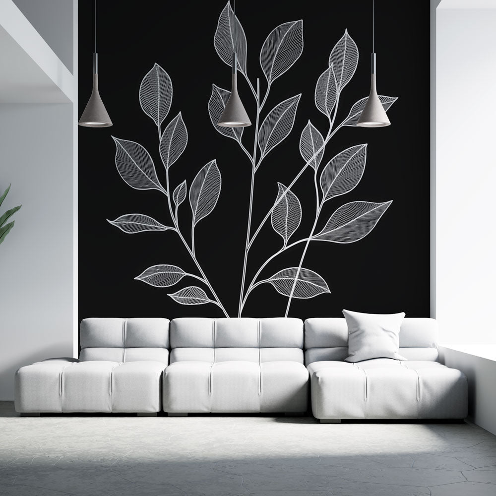 Black and white botanical line art wallpaper creating drama in a modern living room with minimal furniture