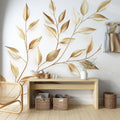 Botanical gold leaf wallpaper creating an elegant atmosphere in a bright living room with modern furniture